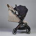 Beige and black stroller with Nuna branding on a gray background