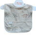A baby bib with a dinosaur print, featuring a front pouch pocket shown on a white background with a Menoum Menoum brand label.
