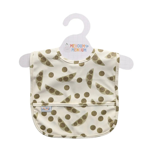 a sleeveless baby bib with green peas on a beige fabric set on a hanger on a white background