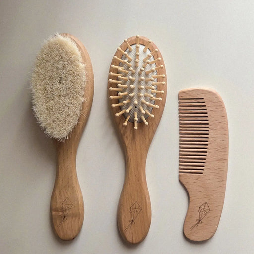 flatlay of children's hair brushes and comb