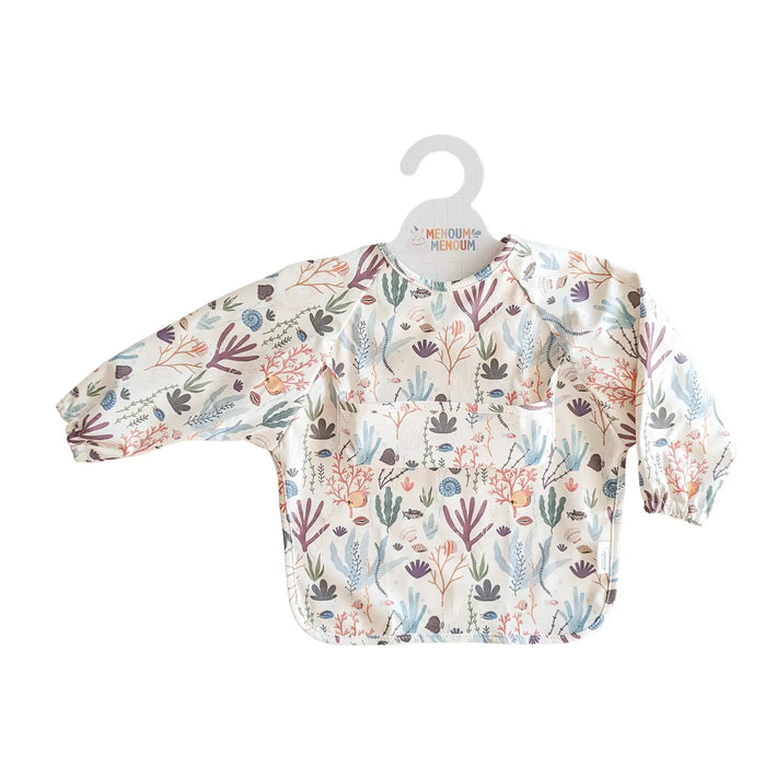 ocean-patterned baby bib on a hanger with Menoum Menoum branding.