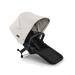 Baby stroller sibling seat with beige canopy and black seat on a white background