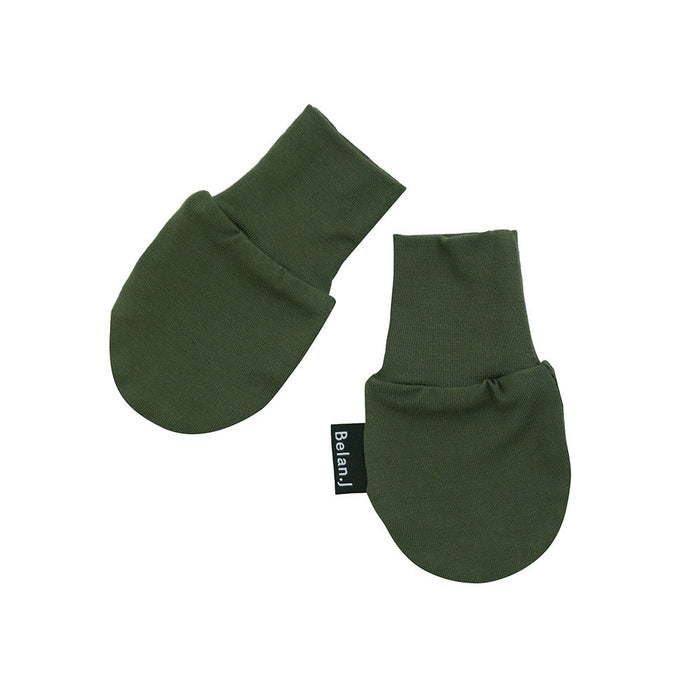 Pair of green baby mittens with a visible brand label on a white background