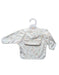 Baby bib with long sleeves on a hanger against a white background