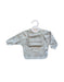 Baby bib with long sleeves and front pocket on a hanger against a white background