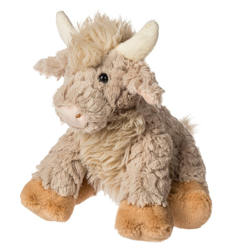 Plush toy highland cow on a white background