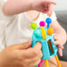 caption-Child reaches for sensory rich pull toy