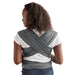 Woman wearing a gray wrap carrier on a white background
