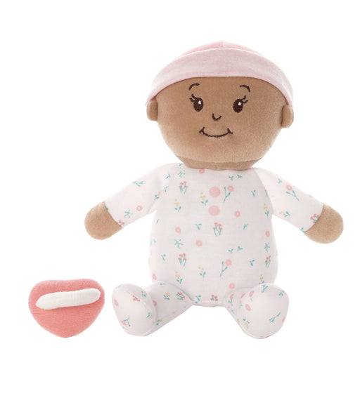 Stuffed toy baby doll with a pink hat and floral outfit on a white background