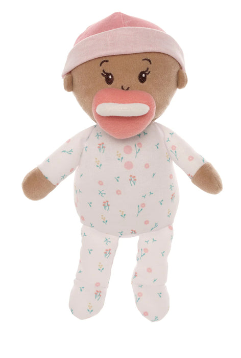 Stuffed toy baby doll with a pink hat and floral outfit on a white background