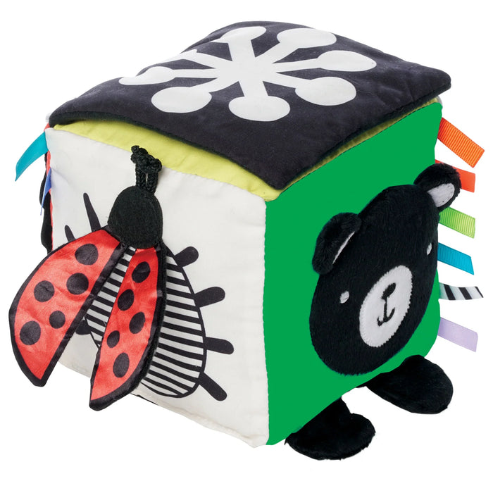Colorful baby cube with animal and ladybug designs on a white background