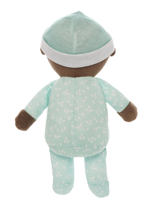 Stuffed toy baby in a green outfit with a white hat on a white background