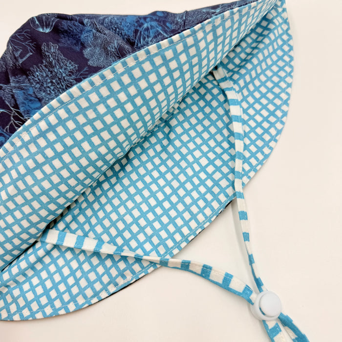 Blue and white checkered fabric with a strap on a beige background