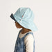 Child wearing a blue checkered hat on a light gray background