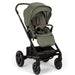 Green Nuna stroller with a black frame on a white background