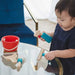 Child playing cleaning with colorful toys on a glass table