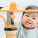 Child playing with a toy ladder in a bright room