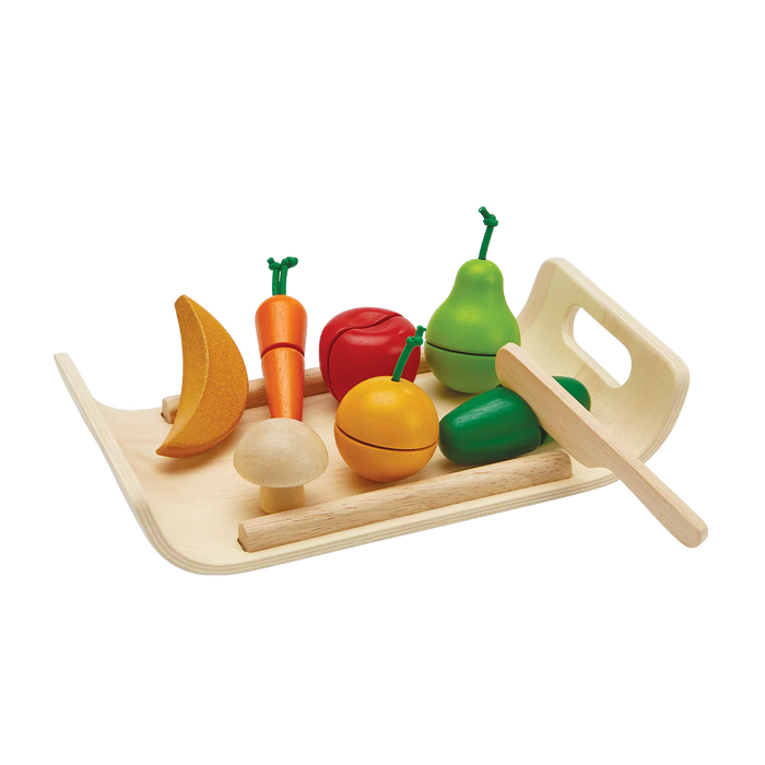 Wooden toy fruits and vegetables set on a tray with a wooden knife on a white background