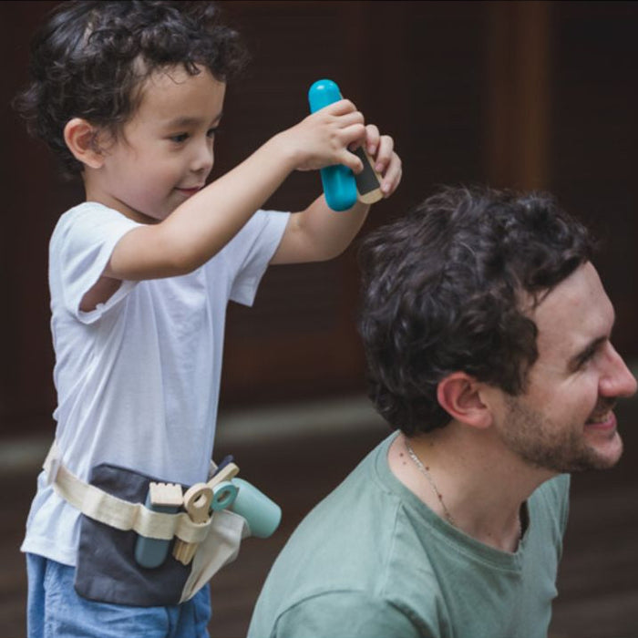 Child pretending to give parent a new hairstyle