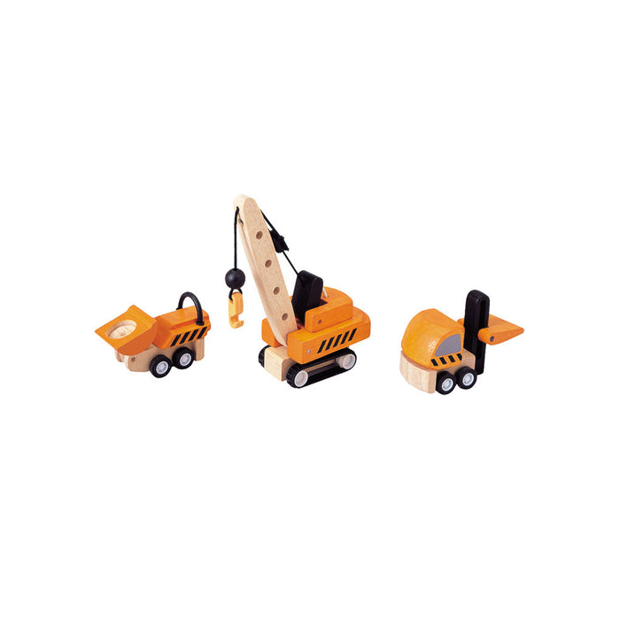 Set of toy construction vehicles on a white background