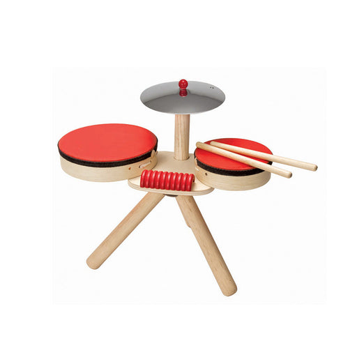 Children's drum set with red drums and wooden stand on a white background