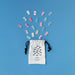Colorful game pieces spilling out of a white drawstring bag with black fish design on a blue background