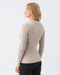 Woman wearing a beige ribbed sweater on a white background