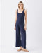 Woman wearing a navy blue maternity jumpsuit on a white background