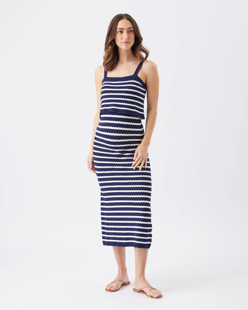 Woman wearing a blue and white striped dress on a white background