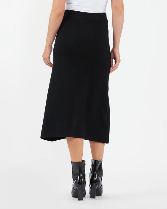 Person wearing a black skirt on a white background