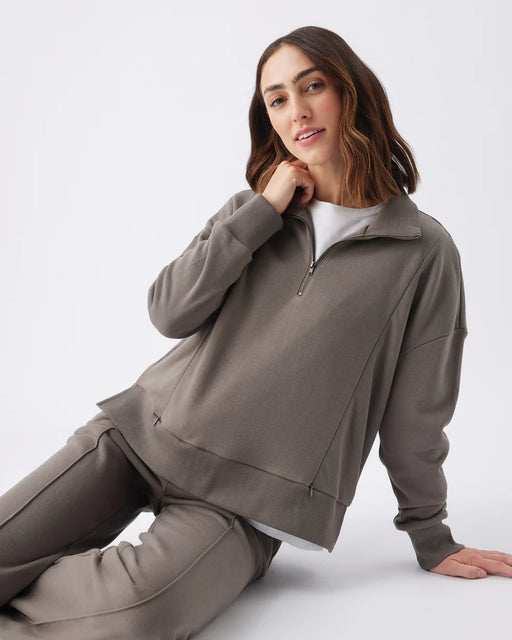 Woman wearing a brown matching lounge set on a white background