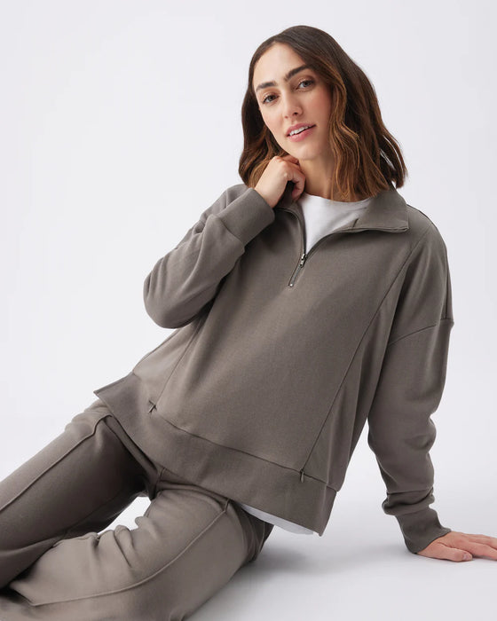 Woman wearing a brown matching lounge set on a white background