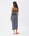 Woman wearing a navy and white striped dress on a white background