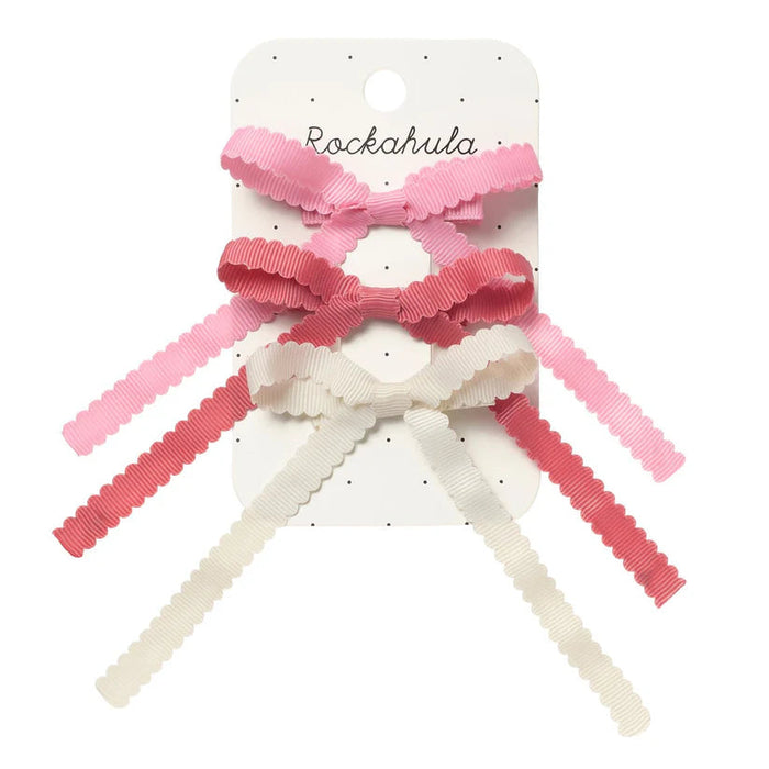 Set of pink and white hair bows on a Rockahula branded card.