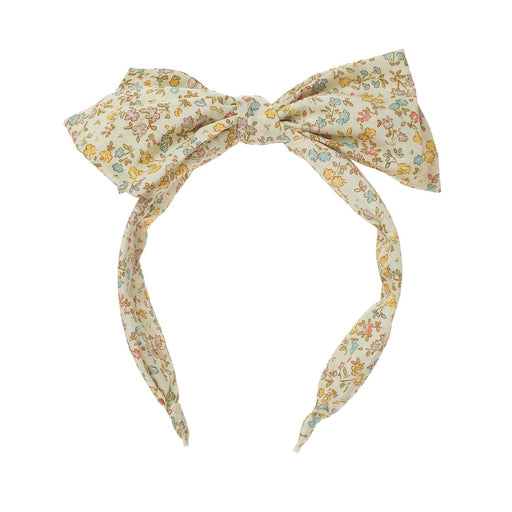 Floral patterned headband with a bow on a white background