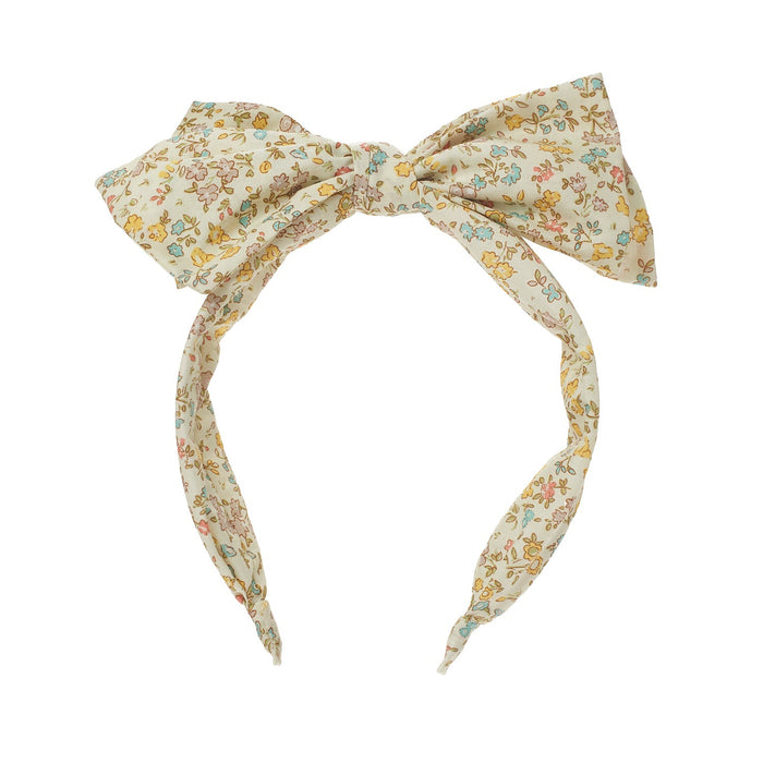 Floral patterned headband with a bow on a white background