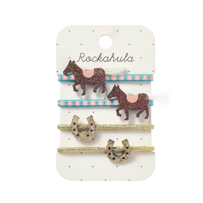 Set of hair accessories with horse and horseshoe designs on a Rockahula branded card.