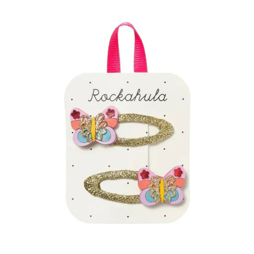 Butterfly-themed hair clips on a Rockahula branded card with pink handles.