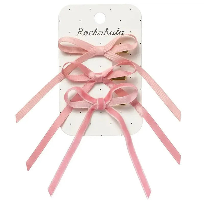 Pink hair bows with ribbons on a Rockahula branded card.