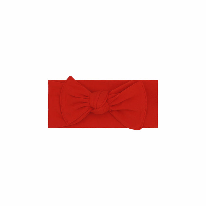 Red headband with a large bow on a white background