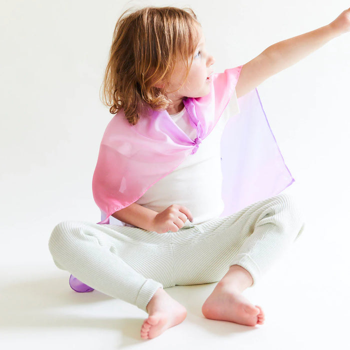 Kid wearing play silk on a white background