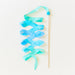 Blue and green silk ribbon on a wooden wand against a white background