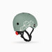 Green helmet with geometric design and red light on a white background