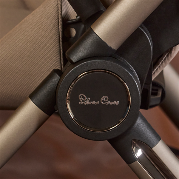 Close-up of a stroller handle with 'Silver Cross' branding.