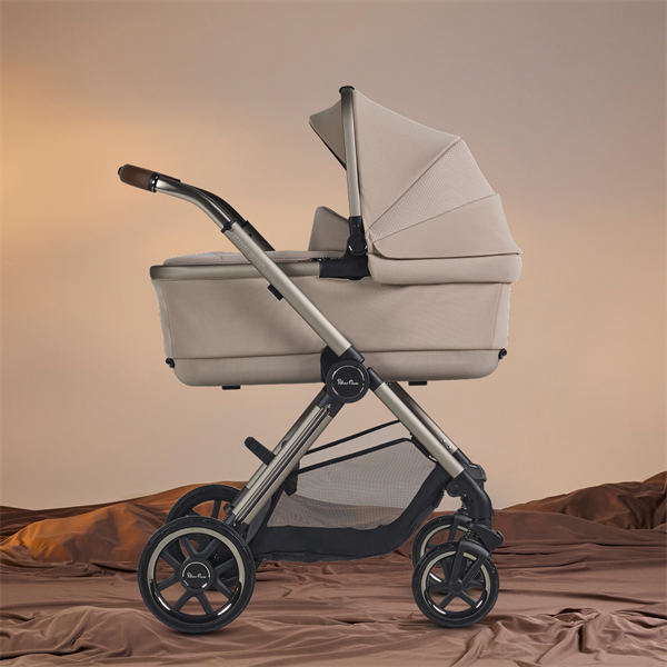 Beige baby stroller on a brown background