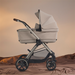 Beige baby stroller on a brown background