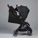 Black stroller with wooden accents on a gray background
