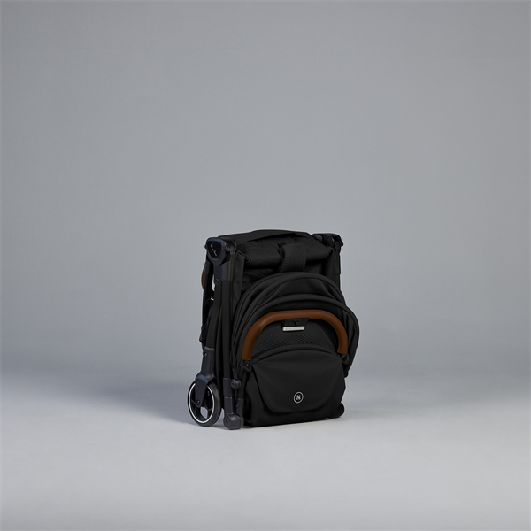 Black backpack with brown accents on a gray background