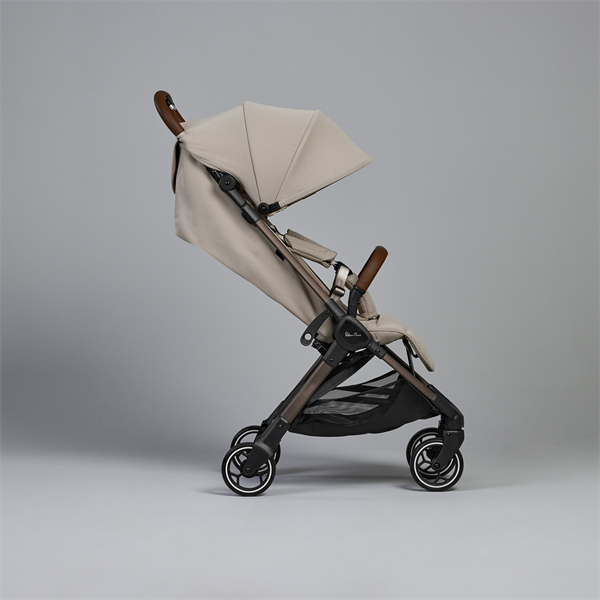 Beige stroller with wooden handles on a gray background