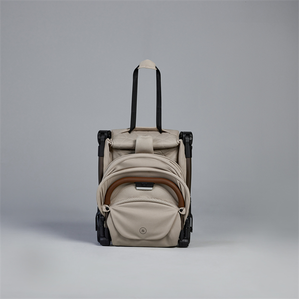 Beige rolling suitcase with backpack attachment on a gray background